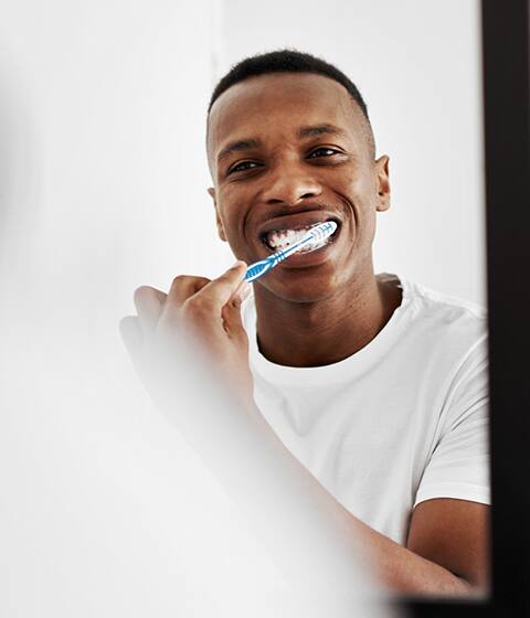 man brushing teeth
